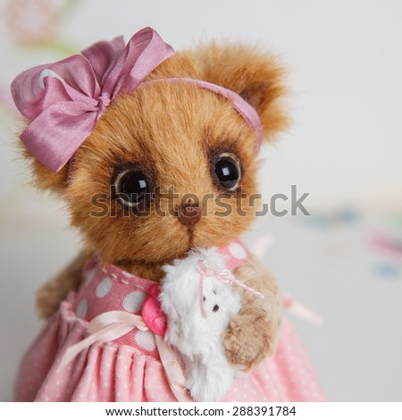 Brown artist Teddy bear in pink clothes with white dog