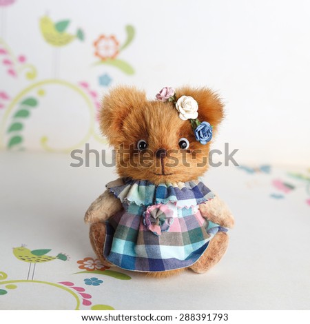 Brown artist Teddy bear in blue clothes with grey dog