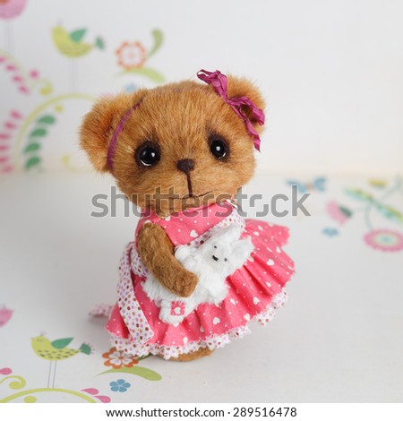 Brown artist teddy bear in pink dress
