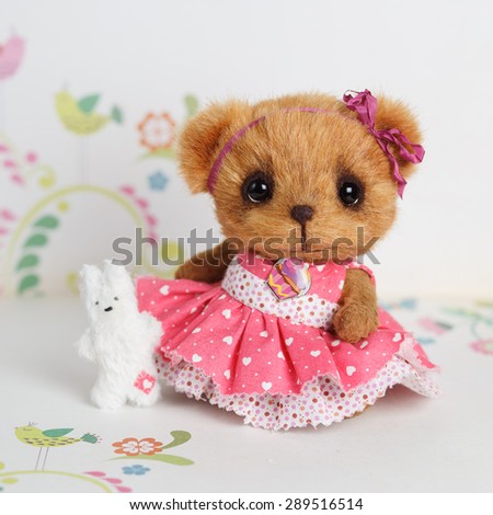Brown artist teddy bear in pink dress