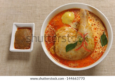 Curry Chicken served in bowl with curry paste