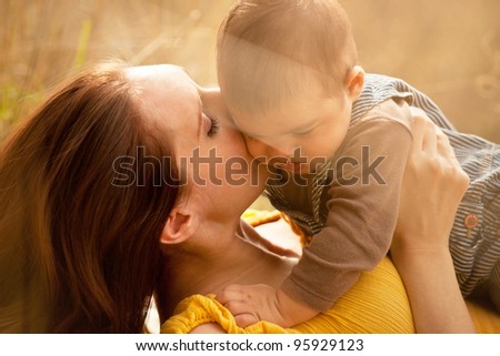 Warm Loving Mother and Son Kiss Cheek Close Up