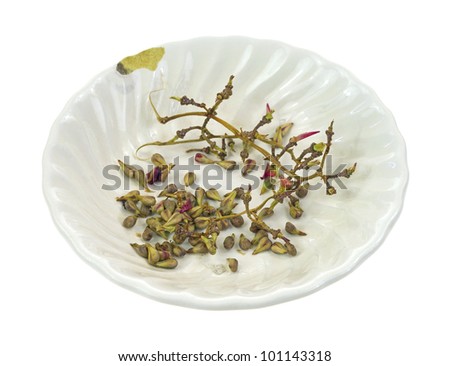 A small bowl used for discarded grape seeds and stems from seeded grapes.