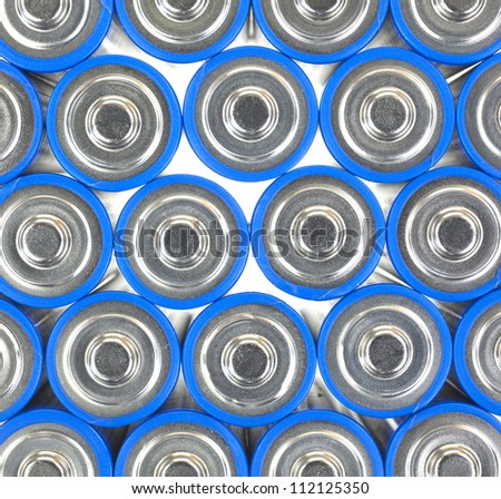 A very close view of the positive end of AA sized batteries.