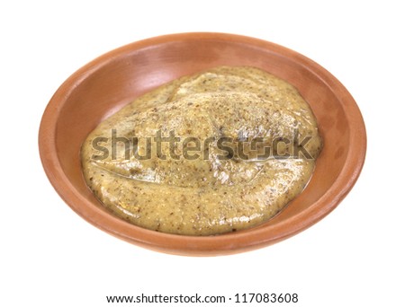 A small amount of all natural almond butter in a red clay dish on a white background.