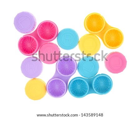 Several contact lens storage cases with covers on a white background.