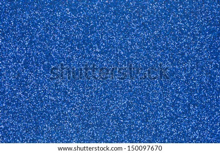 Close view of a bright blue glitter background.