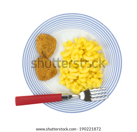 Top view of a meal of macaroni and cheese with two chicken nuggets on a blue striped plate with a red handled fork.
