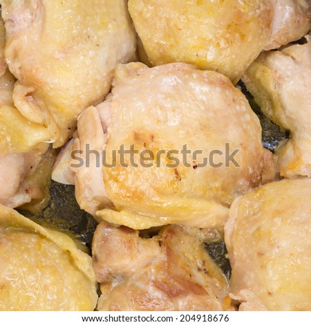 A very close view of chicken thighs that have been cooked in a skillet.