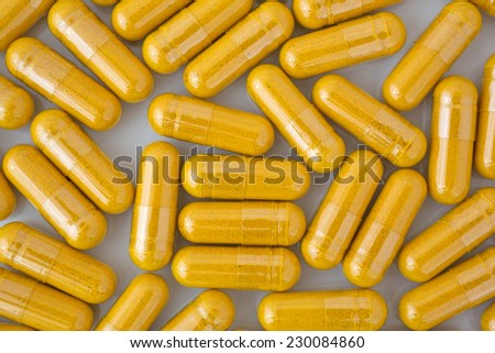 Close view of a group of turmeric herbal capsules.