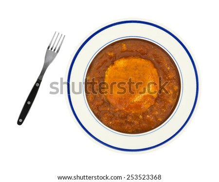 Top view of a serving of chicken parmagiana patty in a tomato sauce with a fork to the side on a white background.