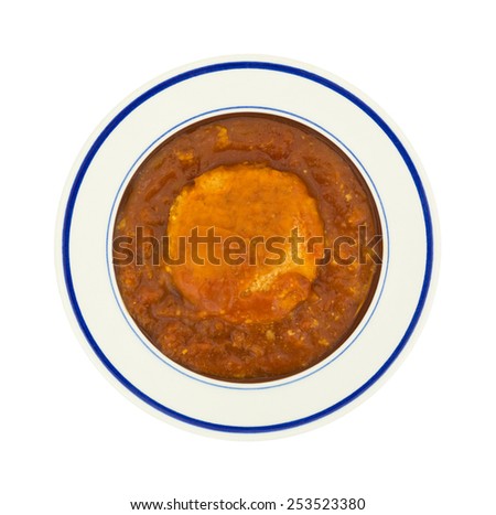 Top view of a serving of chicken parmagiana patty in tomato sauce on a white background.