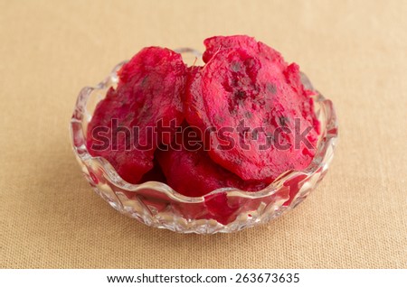A small bowl filled with slices of prickly pear cactus on a tan table cloth.