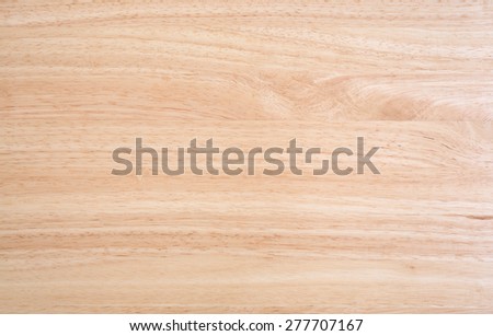 A laminated wood table top illuminated by natural light.