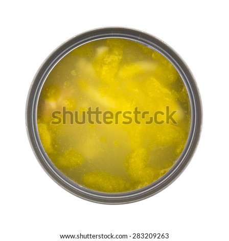 Top view of an opened can of cold chicken noodle soup on a white background.