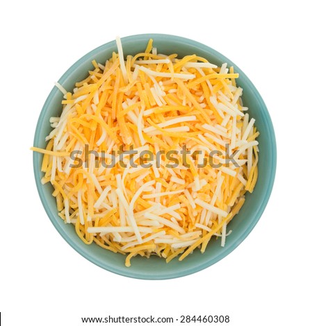 Top view of a small bowl filled with shredded white cheddar, sharp cheddar and mild cheddar cheeses isolated on a white background.