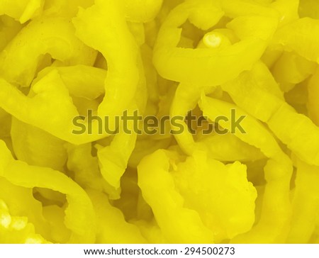 A very close view of canned crinkle cut banana peppers.