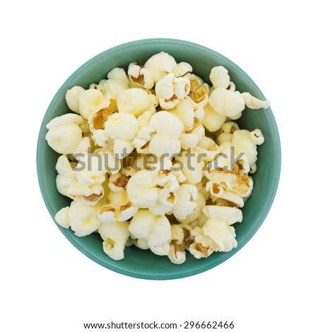 Top view of a small bowl filled with a serving of white cheddar cheese flavored popcorn isolated on a white background.