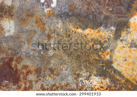 A very close view of a putty knife with rust and dried spackle.