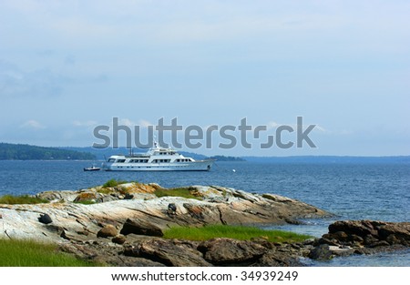 New England coast and large motor yacht