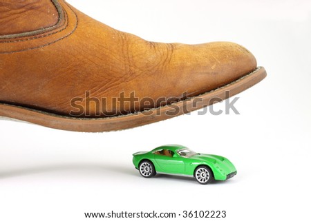 stock-photo-a-green-toy-sports-car-about-to-be-stepped-on-by-a-large-men-s-boot-36102223.jpg