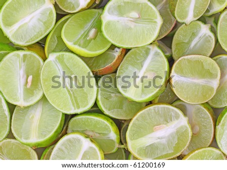 Close view of a layer of cut and sliced key limes.