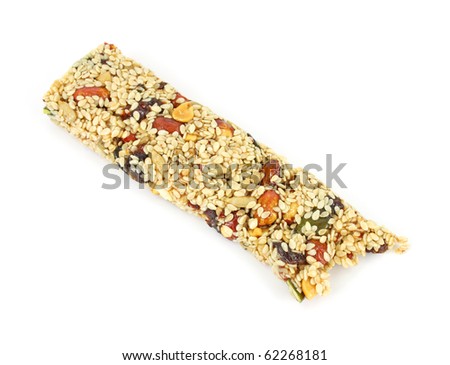 Sesame seed covered fruit and nut energy bar that has been bitten on a white background.