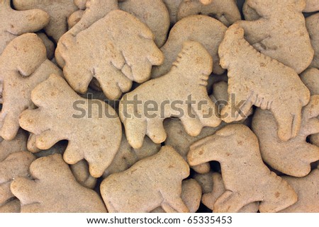 A layer of many chocolate flavored animal crackers.