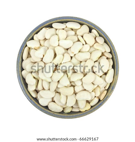 An old bowl filled with large lima beans on a white background.