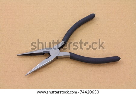 A new pair of needle-nose pliers that are opened on a white background.