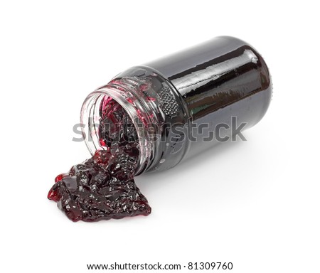 Front view of a jar of grape jelly with the contents spilling onto a white surface.