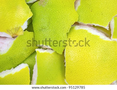 The green and yellow peelings of a pummelo fruit.