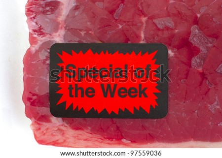 A bright special of the week sticker on a package of beef.