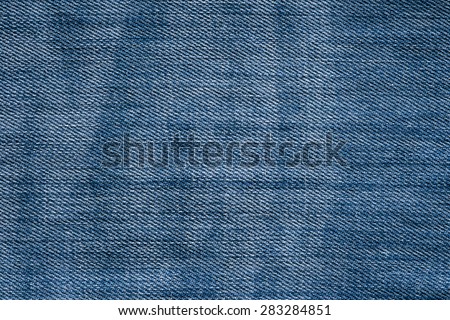 Close up picture of bleached blue jeans.