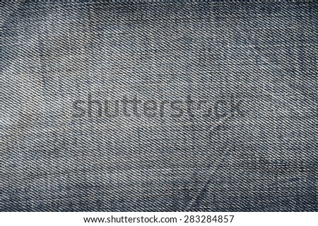 Close up picture of bleached blue jeans.