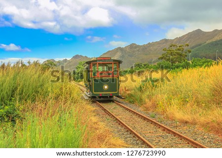 Franschhoek Wine Tram hop-on hop-off tour, one of the best ways to discover Franschhoek Valley in scenic landscape of Wine Region, near Cape Town, South Africa.