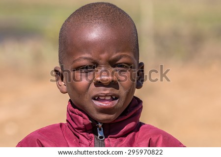 UMkhuze Game Reserve, South Africa - August 24, 2014: Portrait of a poor and worried South African child on the road leading to UMkhuze