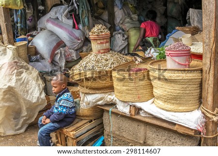 Arusha, Tanzania - January 2, 2013: Lone black child in a market of the town
