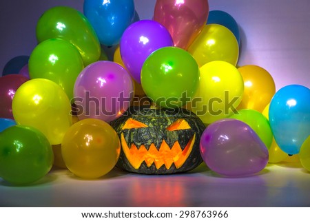 Halloween Pumpkin Party. A pumpkin head with hat, celebrating halloween with colorful balloons. Background dark, at night.