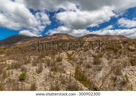 View over the lunar landscape around Queenstown, Tasmania, Australia. The road out of Queenstown to Hobart goes up Mount Lyell. Here you get to see just how damaged the land really is.