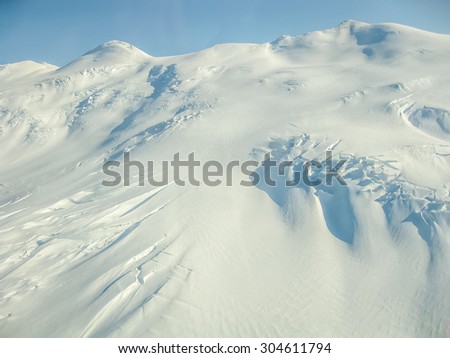 Aerial view of a snowy mountain on Wrangell St. Elias National Park in Alaska in winter, USA.