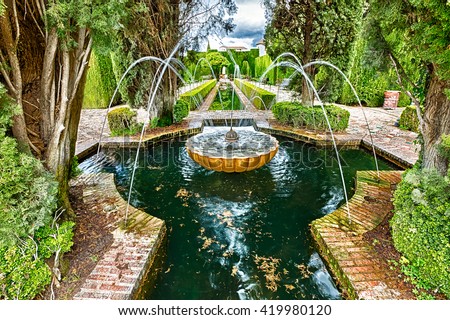 Close up of fountain in the famous avenue of cypress trees, Generalife gardens near Alhambra complex, Granada, Andalucia, Spain, one of the most beautiful in the world and is a Unesco heritage.