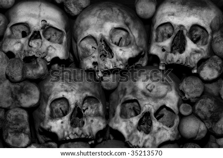 Skulls amidst a pile of bones in an ossuary