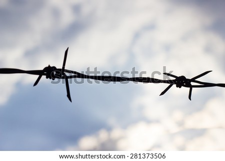 Silhouette of barbed Wire on white cloud background