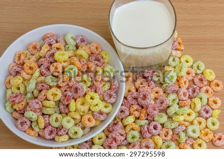 dish of colorful Cereals a cup of milk and Cereals on the wood texture