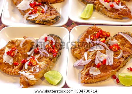 fried pickled fishes with chili, lemon and shallots