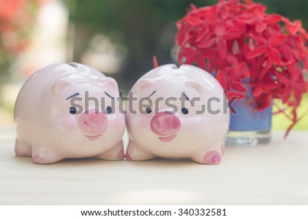 pink piggy bank lover with glass of flower in vintage style