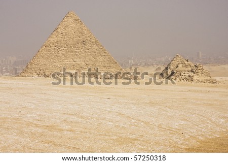 The Great Pyramid on the Giza plateau against the backdrop of a smog filled Cairo city