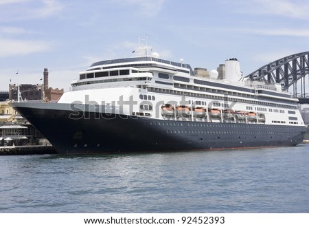 A modern luxury cruise ship anchored at the port