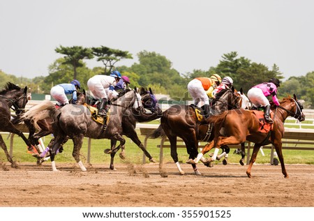 Race horses galloping at the track